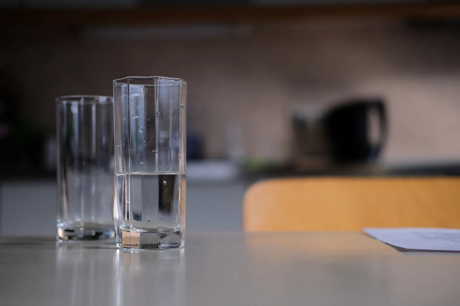 Two glasses of purified water on a table, representing reliable filtered water for rental properties.