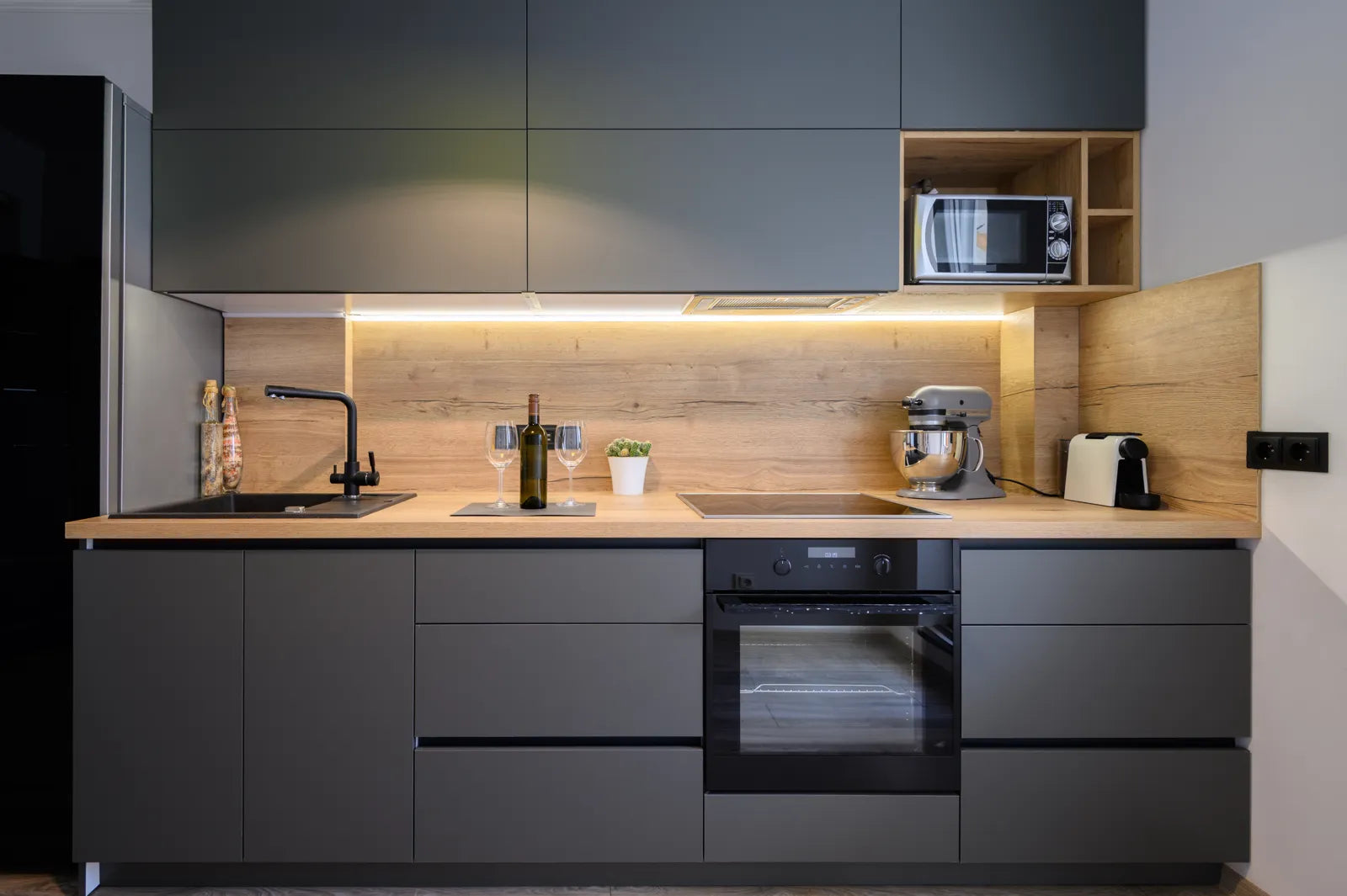 Modern apartment kitchen with a sink, ideal for installing a water filtration system.