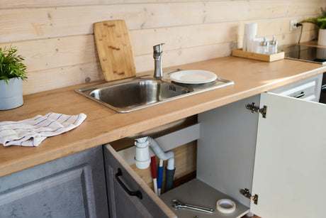 Modern kitchen sink with clean, minimalist design, showcasing the ideal space to install a compact and efficient water filter for rentals.