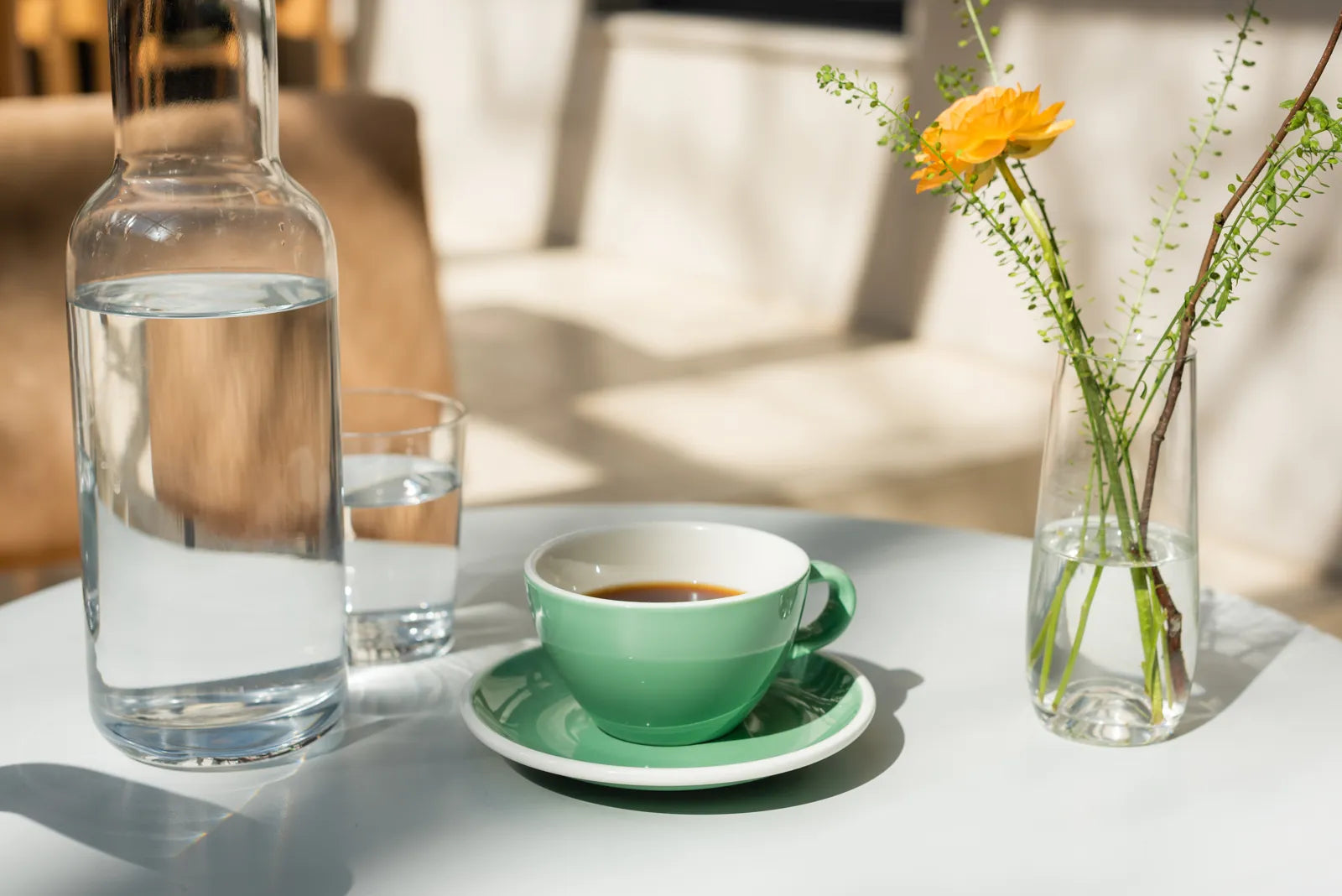 A glass carafe of filtered water sits ready for specialty coffee brewing.