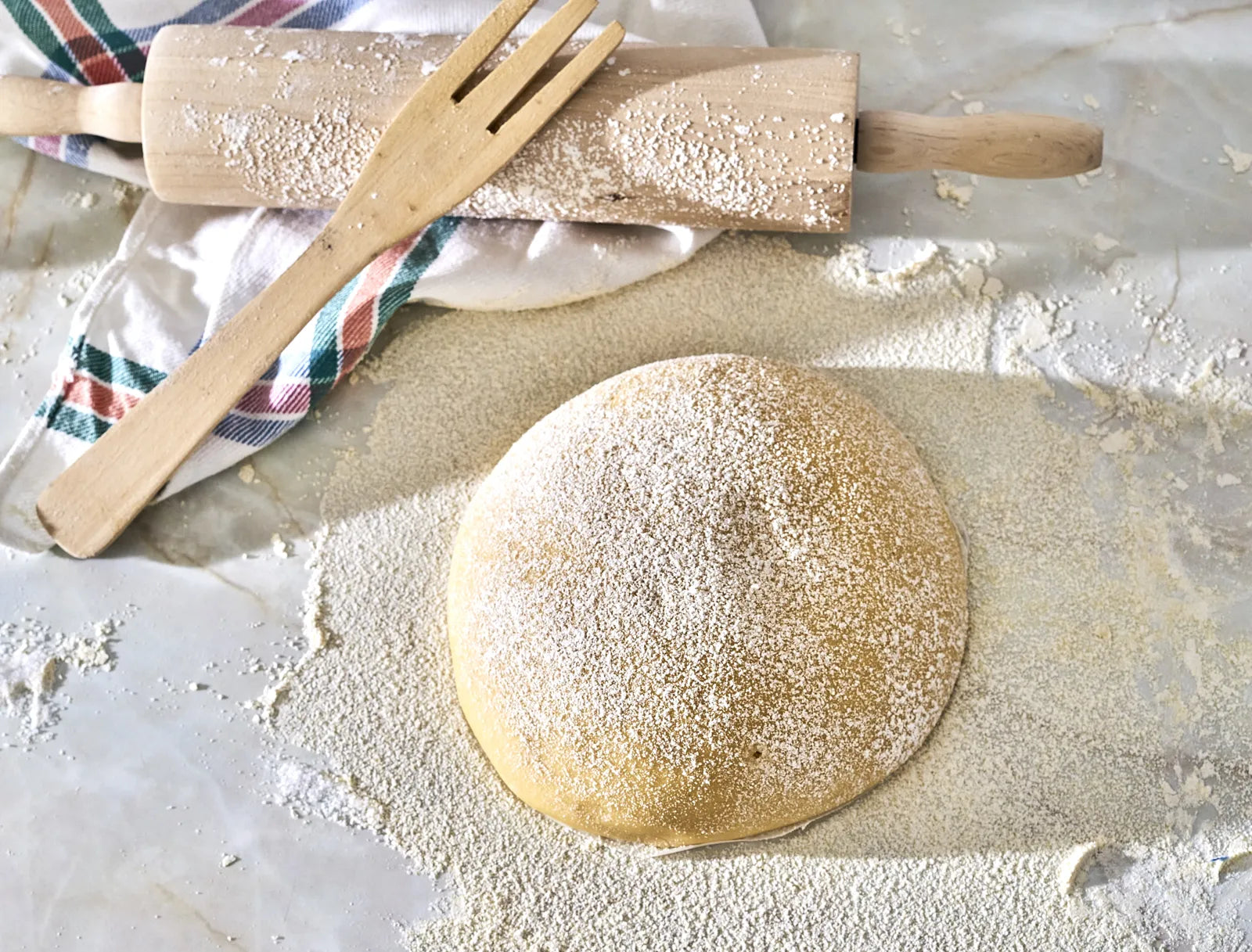 Prepared sourdough dough dusted with flour, ready for baking after mixing with the ideal water for sourdough fermentation.