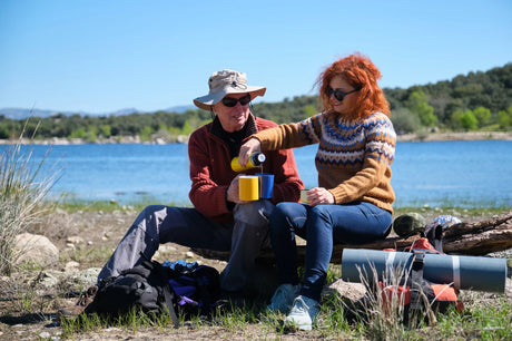 Happy family enjoying fresh, clean drinking water from an RV faucet at a scenic campsite after successfully eliminating sulfur and rotten egg odors