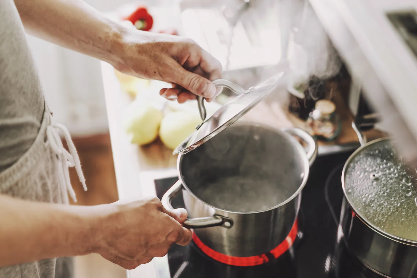 Stainless steel pot boiling water on an electric stovetop, depicting the core disinfection method of boiling water to kill harmful microbes during a boil water advisory.
