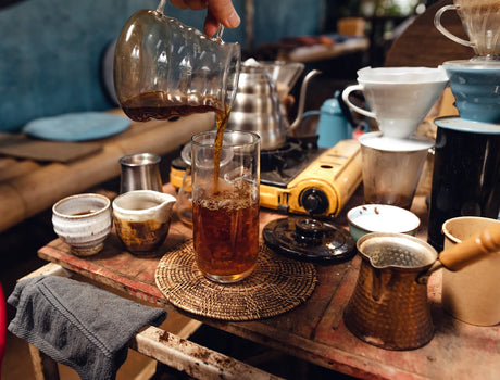 A barista pours brewed coffee, showcasing RO water’s role in great homebrewing.