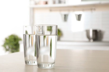 Two clear glasses of water illustrating the visual clarity aspect of water quality testing.